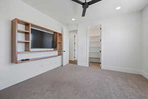 Unfurnished bedroom with carpet flooring, recessed lighting, baseboards, and a walk in closet