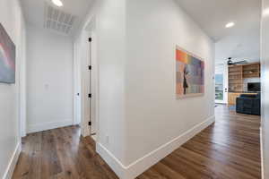 Hallway with hardwood / wood-style flooring