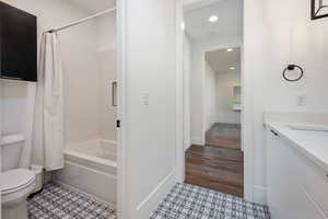 Full bathroom with vanity, toilet, and shower / bath combo with shower curtain