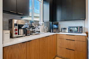 Kitchen featuring light stone countertops and backsplash