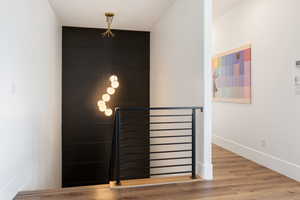 Stairs featuring hardwood / wood-style floors