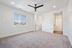 Unfurnished bedroom with recessed lighting, baseboards, light colored carpet, and visible vents