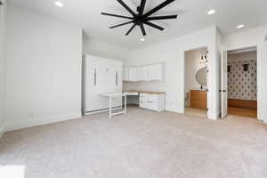 Unfurnished bedroom featuring baseboards, recessed lighting, connected bathroom, and light colored carpet