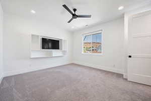 Interior space with baseboards, a ceiling fan, carpet flooring, and visible vents