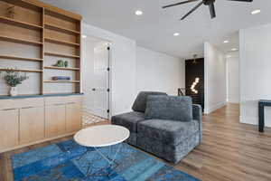 Sitting room with light hardwood / wood-style floors and ceiling fan