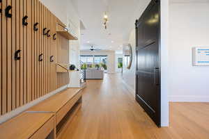 Mudroom with a barn door and light hardwood / wood-style flooring