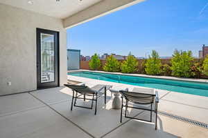 View of pool with a fenced in pool, a fenced backyard, and a patio area