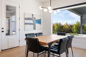 Dining space featuring a notable chandelier and light hardwood / wood-style flooring