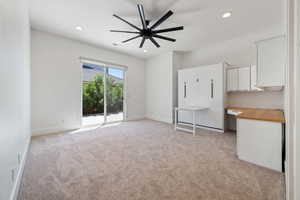 Interior space featuring recessed lighting, baseboards, and light carpet