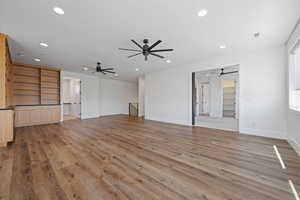 Unfurnished living room featuring recessed lighting, ceiling fan, visible vents, and light wood-type flooring