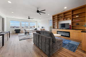 Living room featuring light hardwood / wood-style floors and ceiling fan