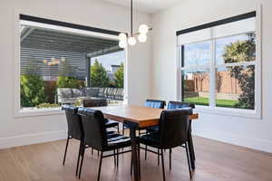 Dining area featuring light hardwood / wood-style floors and a notable chandelier