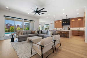 Living area with recessed lighting, a ceiling fan, visible vents, and light wood finished floors