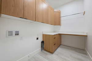 Laundry room with washer hookup, electric dryer hookup, light wood-type flooring, cabinet space, and baseboards