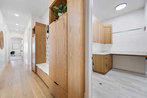 Mudroom featuring baseboards, recessed lighting, and light wood-style flooring