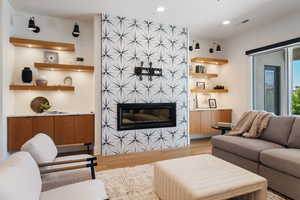 Living area with visible vents, recessed lighting, wood finished floors, and a fireplace