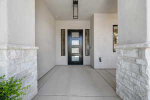 Doorway to property with stucco siding