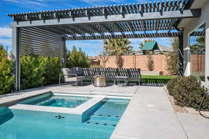 View of pool featuring an in ground hot tub, a pergola, and a patio