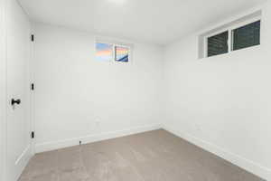 Basement bedroom featuring carpet floors