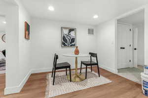 Dining area with light wood-type flooring