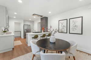 Dining space featuring sink and light wood-type flooring