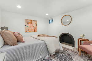 basement Bedroom featuring a fireplace