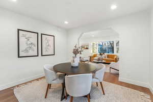 Dining space with hardwood / wood-style floors