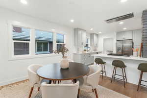 Dining area with sink and light hardwood / wood-style floors