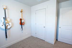 Unfurnished bedroom featuring light colored carpet