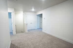 Carpeted empty room featuring a textured ceiling