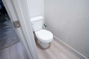 Bathroom featuring wood-type flooring and toilet