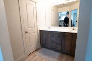 Bathroom with hardwood / wood-style flooring and vanity