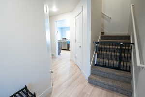 Stairway featuring wood-type flooring