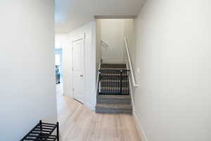 Corridor with light hardwood / wood-style flooring