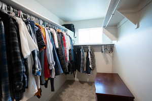 Walk in closet with carpet flooring