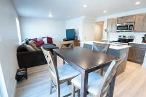 Dining space featuring sink and light wood-type flooring