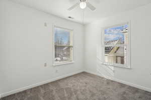 Spare room with carpet, a healthy amount of sunlight, and ceiling fan