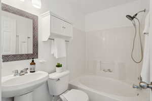 Full bathroom featuring sink, bathing tub / shower combination, and toilet