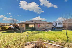 View of front of home featuring a hot tub, a patio area, and a front yard