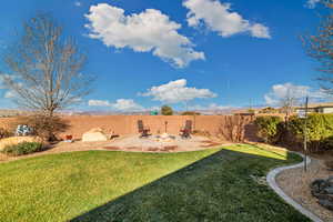 View of yard with a patio and an outdoor fire pit