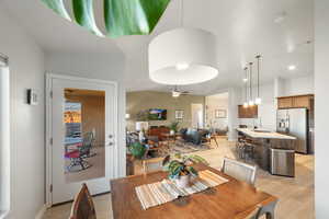 Dining space featuring sink, ceiling fan, and light wood-type flooring