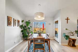 Dining room with light hardwood / wood-style flooring