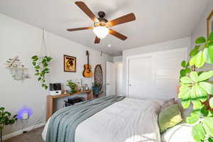 Bedroom featuring a closet, ceiling fan, and carpet flooring