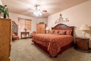 Carpeted bedroom with ceiling fan