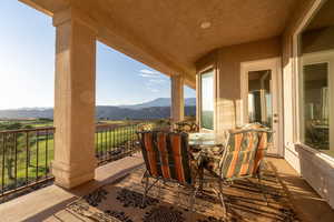 View of patio featuring a balcony and a mountain view