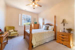 Bedroom with light colored carpet and ceiling fan