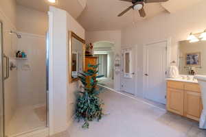 Bathroom featuring vanity, tile patterned floors, a shower with door, and ceiling fan