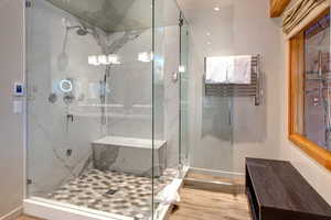 Bathroom with hardwood / wood-style flooring and walk in shower