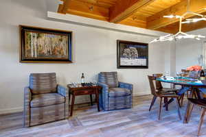 Dining area featuring wood-type flooring, wooden ceiling, and beam ceiling