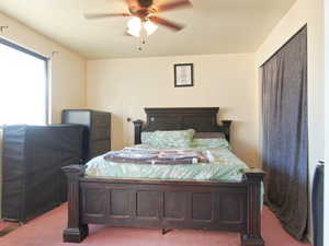 Bedroom featuring ceiling fan and light colored carpet